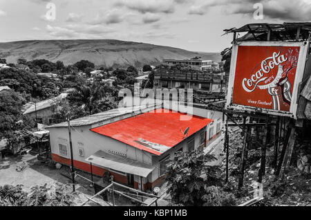 Stylized photo in black and white with red roof and Coca Cola advertising in city Matadi, Democratic Republic of Congo Stock Photo