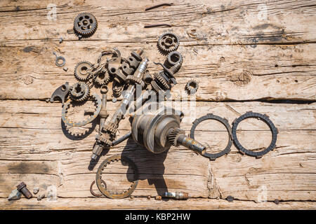 Collection of mechanical parts on old brown wooden planks Stock Photo