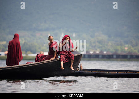 Asia, Myanmar, Shen State, Inle Lake, Boat race competition during Phaung Daw Oo Pagoda Festival, Inn Kaung Village, local monks watching race Stock Photo