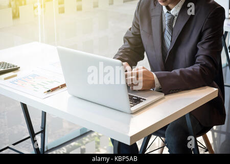 young business crew working with new startup project. Project managers meeting near windows. Analyze plans, papers. Stock Photo