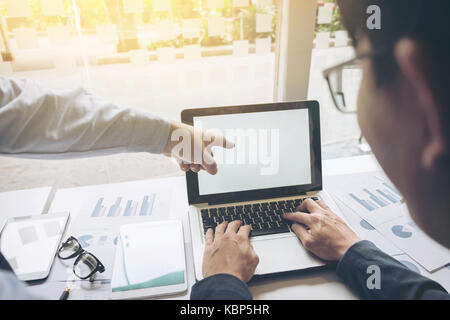 Image of business partners discussing documents and ideas at meeting. Stock Photo