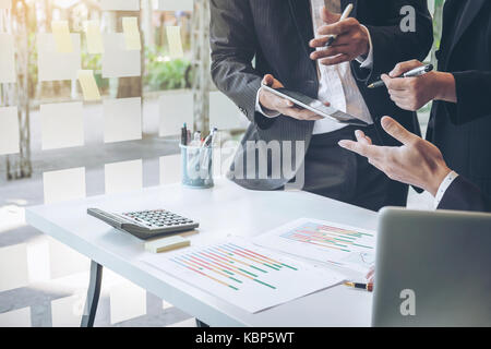 Team process, Business adviser analyzing financial figures denoting the progress in the work of the company. Stock Photo