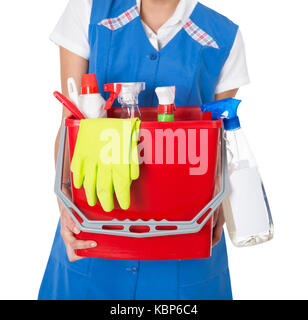 Midsection of female janitor carrying bucket with cleaning equipment against white background Stock Photo