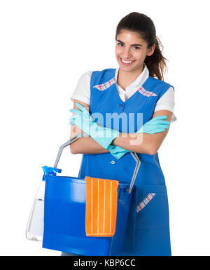 Portrait of confident female worker carrying bucket against white background Stock Photo