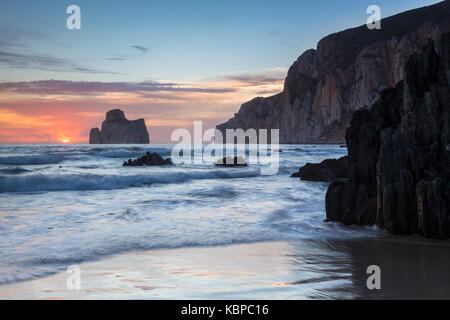 Sunset at Masua beach, in front of the Pan di Zucchero reef. Masua, Sulcis-iglesiente, Iglesias, Sardinia, Italy. Stock Photo