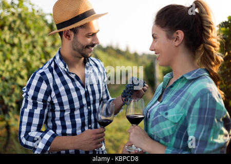 People sampling and tasting wines in vineyard Stock Photo