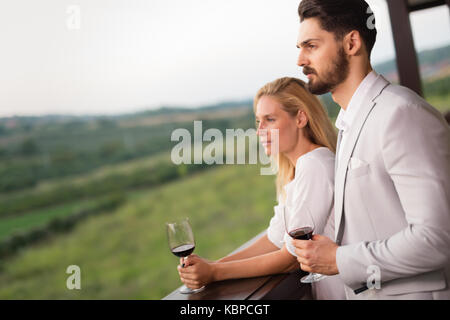 Couple toasting and celebrating with wine Stock Photo