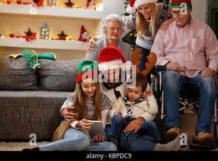 Family with grandma and grandpa enjoy together in Christmas eve Stock Photo