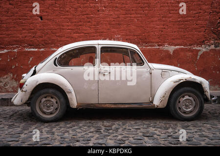 March 2, 2016 San Miguel de Allende, Mexico: a vintage car parked in the cobblestone street of the popular tourist town Stock Photo