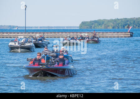 Flotilla of boats return to the harbour at Couchiching Park in Orillia Ontario at the end of the 30th annual Fall Challenge fishing tournament. Stock Photo
