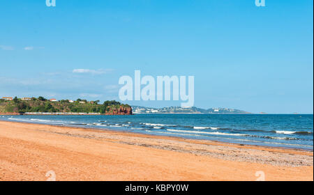Deserted sandy beach at Goodrington Sands, Paignton, Devon, UK with Torquay in the far distance on a clear blue sunny summer's day. Stock Photo