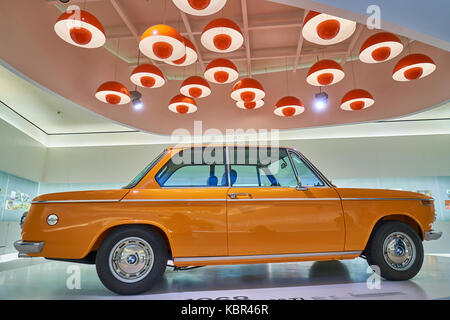 a vintage orange car on display in BMW Museum of Munich in Germany, which is a famous germany auto brand Stock Photo