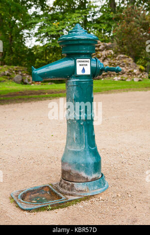 Old water column on the footpath in the park. Latvia Stock Photo