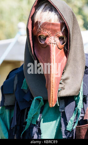 England, Sandwich. Living history re-enactment. Medieval plague doctor, wearing bear stuffed with herbs and spices, hood and neck protection. Stock Photo