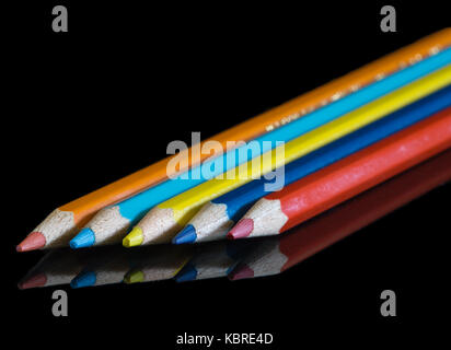 coloured pencils reflected on black surface Stock Photo