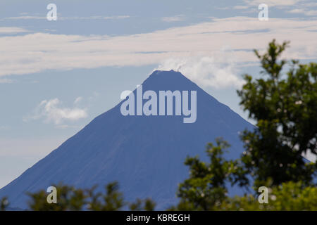 clear afternoon view of the Arenal volcano from across the lake Stock Photo