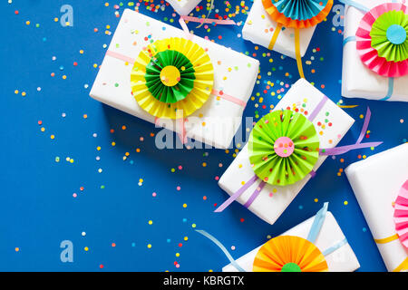 Blue background. Many gifts of different sizes. White gift boxes. Stock Photo