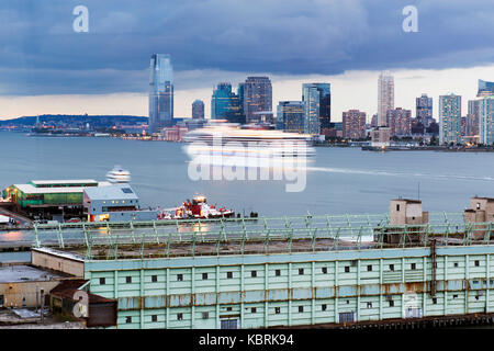 A cruise ship in motion passing by the Hudson river between New York city and New Jersey Stock Photo