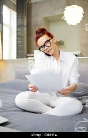 Attractive Freelancer Using Smartphone Stock Photo