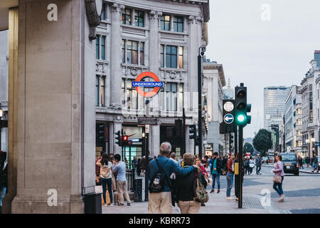 People walking on Oxford street near entrance to Oxford Circus tube station. It is the busiest rapid-transit station in the United Kingdom. Stock Photo