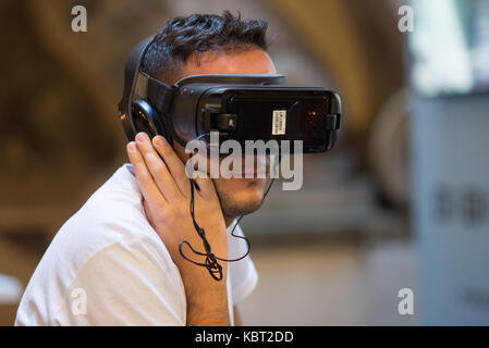 Florence, Italy. 30 Sept, 2017. A guy tries a Virtual reality headsets at Wired Next Fest 2017 in Palazzo Vecchio in Florence, Italy. Credit: Mario Carovani/Alamy Live News. Stock Photo