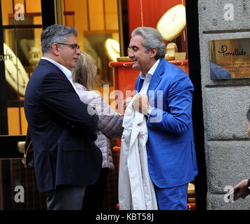 Milan, Pietro Lorenzetti walking with his wife in the center Professor Pietro Lorenzetti, renowned plastic surgeon who has several studies throughout Italy, often frequents Barbara D'Urso's living room on Sunday Live on channel 5 when ALBERICO LEMME, discussed the character who always argues for his method of slimming with his diets (several characters from the world of entertainment have entrusted to him, primarily Silvio Berlusconi and Briatore). He is surprised to walk through the streets of the quadrilateral while curious among the showrooms of the boutiques, along with his wife and a frie Stock Photo