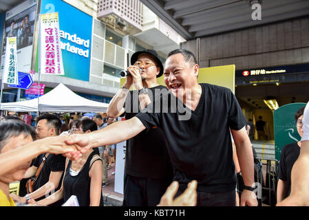 Hong Kong. 1st October, 2017. Inspired by the passing crowds pro democracy advocate Occupy Central leader, Professor Benny Tai waves and greets the marchers. Hong Kong's 68th National Day is marked by a mass rally. Various political parties called for the rally in light of recent suppression of those speaking out against what they see as the disintegration of the Basic Law and the 'one country, two systems'' .Dubbed as the 'Anti-authoritarian rally-No more political Suppression. Credit: ZUMA Press, Inc. Credit: ZUMA Press, Inc./Alamy Live News Stock Photo