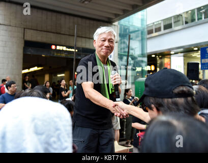 Hong Kong. 1st October, 2017. Inspired by the passing crowds pro democracy advocate Rev Chu Yiu-ming waves and greets the marchers. Hong Kong's 68th National Day is marked by a mass rally. Various political parties called for the rally in light of recent suppression of those speaking out against what they see as the disintegration of the Basic Law and the 'one country, two systems'' .Dubbed as the 'Anti-authoritarian rally-No more political Suppression. Credit: ZUMA Press, Inc. Credit: ZUMA Press, Inc./Alamy Live News Stock Photo
