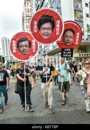 Hong Kong. 1st October, 2017. Protesters hold images of those they want removed form office.Various political parties called for the rally in light of recent suppression of those speaking out against what they see as the disintegration of the Basic Law and the 'one country, two systems'' .Dubbed as the 'Anti-authoritarian rally-No more political Suppression. Step Down Rimsky Yuen'', they are calling for and end to police action against those that speak out and the removal of Secretary of Justice, Rimsky Yuen Kwok-keung, from office. Credit: ZUMA Press, Inc./Alamy Live News Stock Photo