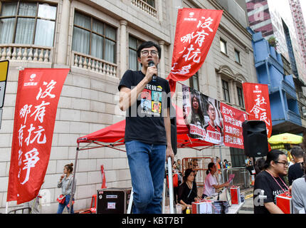 Hong Kong. 1st October, 2017. Activist and politican, Avery Ng Man-yuen, encourages the crowd as they pass.Hong Kong's 68th National Day is marked by a mass rally. Various political parties called for the rally in light of recent suppression of those speaking out against what they see as the disintegration of the Basic Law and the 'one country, two systems'' .Dubbed as the 'Anti-authoritarian rally-No more political Suppression. Credit: ZUMA Press, Inc./Alamy Live News Stock Photo