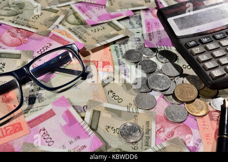 Rupees bills account eyeglass and calculator Stock Photo