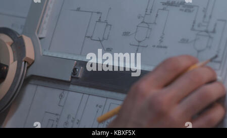 Close up of Architect hand sketching a construction project at work place. repair, building and home concept - close up of male hands making changes to blueprint. Stock Photo
