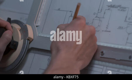 Close up of Architect hand sketching a construction project at work place. repair, building and home concept - close up of male hands making changes to blueprint. Stock Photo
