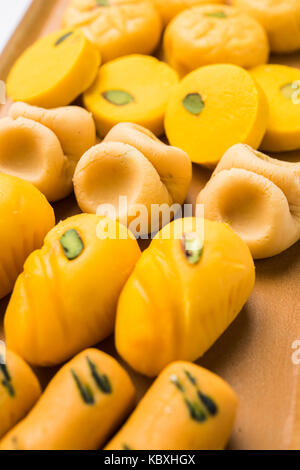 stock photo of collection of variety of sweets or orange peda or pedha or pera made up of milk, khoya, sugar , saffron etc. selective focus Stock Photo