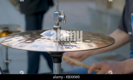 The drummer in action. A photo close up process play on a musical instrument. percussions drums with drumsticks on it close-up. Hand holding drumsticks playing drums Stock Photo