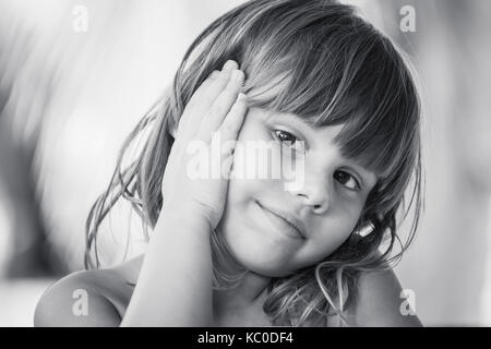Outdoor portrait of a cute black little boy sited on a bench Stock Photo -  Alamy
