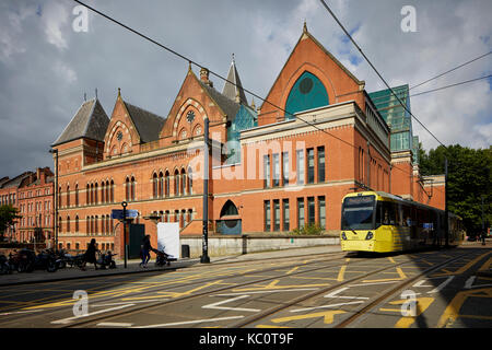 Metrolink tram M5000 model passing Minshull Street Crown Court by architect Thomas Worthington in the Flemish Gothic style and a diamond box junction Stock Photo