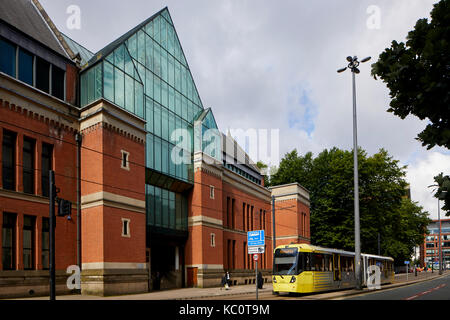 Metrolink tram M5000 model passing Minshull Street Crown Court by architect Thomas Worthington in the Flemish Gothic style Stock Photo