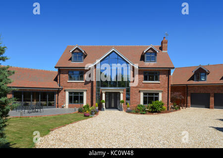 Simon & Gail Abdilla with daughter Sophie, with their new self-build house in Exton, Devonshire, UK Stock Photo