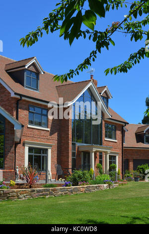 Simon & Gail Abdilla with daughter Sophie, with their new self-build house in Exton, Devonshire, UK Stock Photo