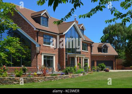 Simon & Gail Abdilla with daughter Sophie, with their new self-build house in Exton, Devonshire, UK Stock Photo