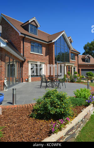 Simon & Gail Abdilla with daughter Sophie, with their new self-build house in Exton, Devonshire, UK Stock Photo