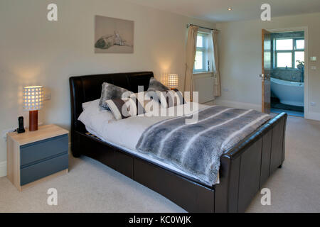 Simon & Gail Abdilla with daughter Sophie, with their new self-build house in Exton, Devonshire, UK Stock Photo