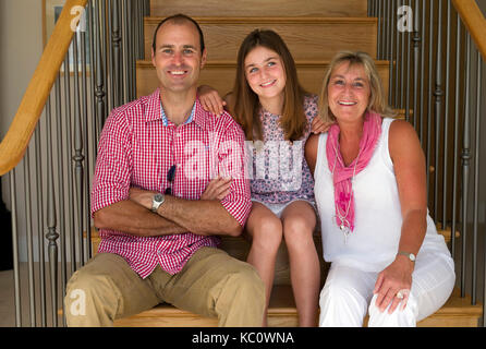 Simon & Gail Abdilla with daughter Sophie, with their new self-build house in Exton, Devonshire, UK Stock Photo