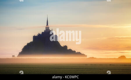 Beautiful panoramic view of famous Le Mont Saint-Michel tidal island at sunrise. Normandy, northern France Stock Photo