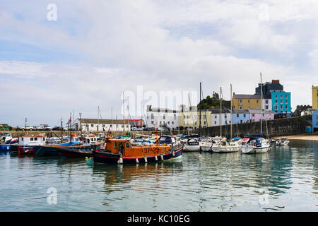 Boats and lifeboat moored in the old harbour at high tide. Tenby, Carmarthen Bay, Pembrokeshire, Wales, UK, Britain Stock Photo