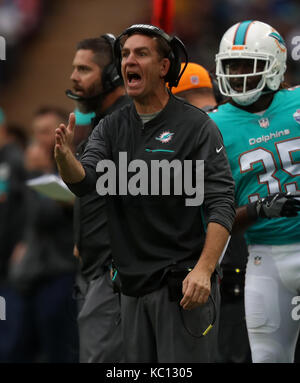 Miami Dolphins head coach Adam Gase talks to players during an NFL ...