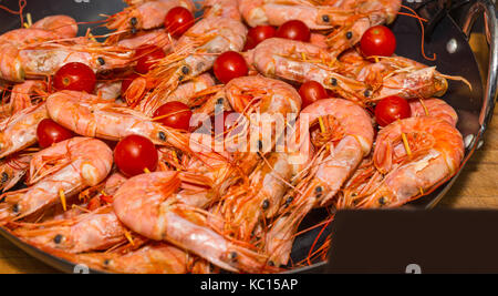 Appetizing cooked shrimps with tomatoes at food festival, food and beverage concept Stock Photo