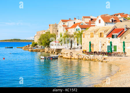 PRIMOSTEN TOWN, CROATIA - SEP 4, 2017: View of beautiful beach in Primosten old town with colorful houses, Dalmatia, Croatia. Stock Photo