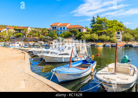 Fishing boats mooring in small bay near Primosten town, Dalmatia, Croatia Stock Photo